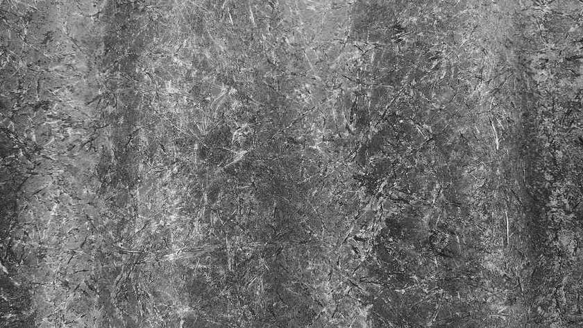 Surface de pierre grise avec multiples fissures, craquelures et dégradations