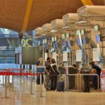 Guichets d'enregistrement à un aéroport avec des personnes en file d'attente